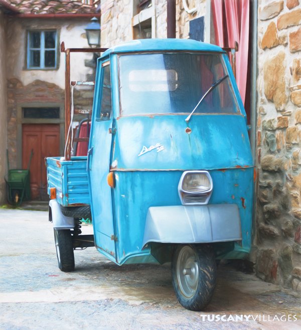 A little blue Ape van parked in a stone lane in Aramo