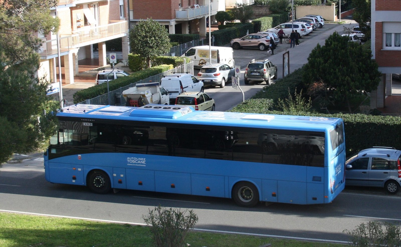 A blue Autolinee Toscane coach on a country road