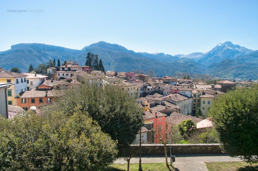 The rooftops of Barga with the Apuan Alps behind under a blue sky