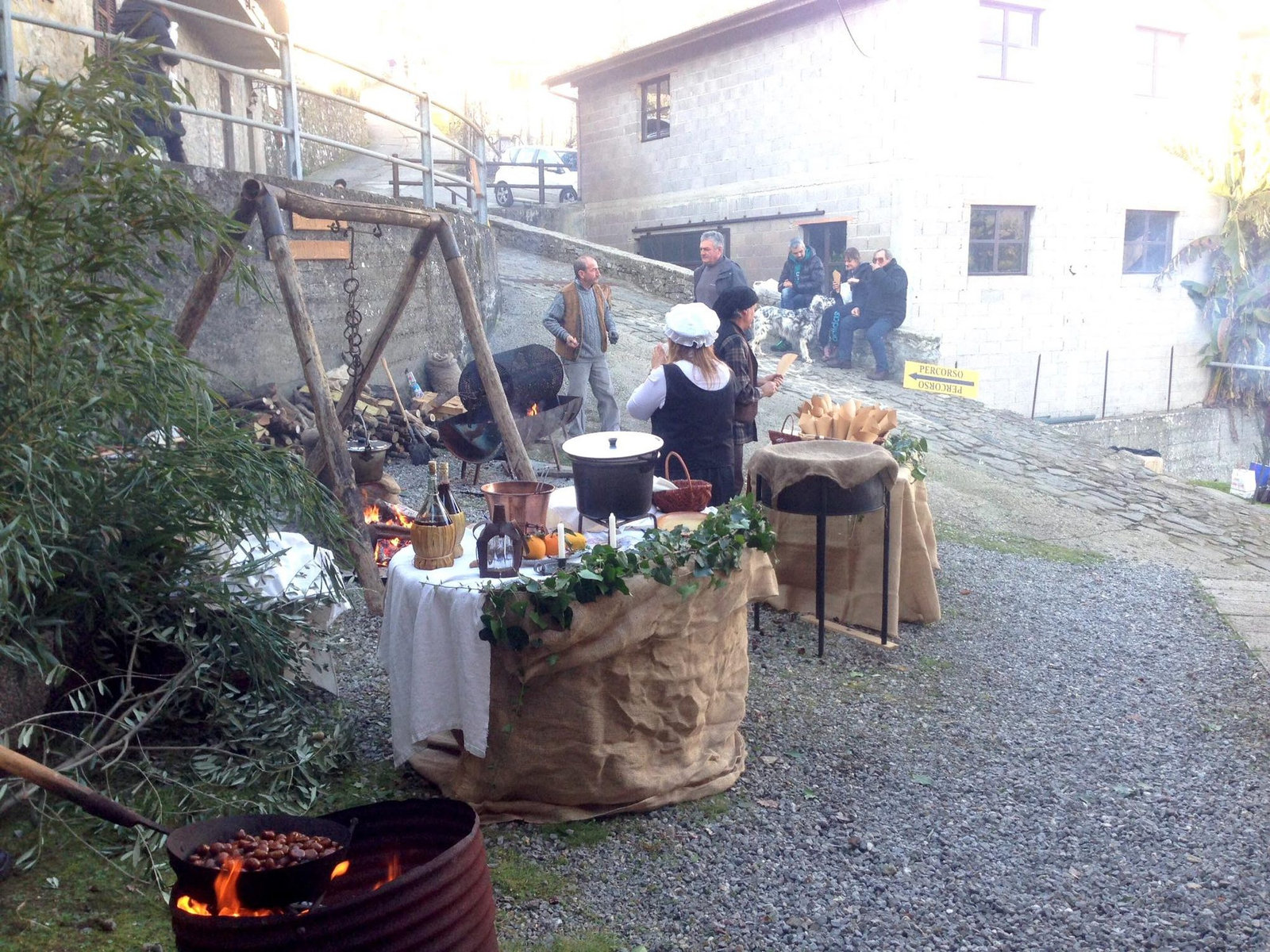 The necci stall at the Monte di Villa chestnut festa, with chestnuts roasting on the fire