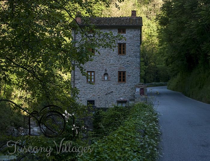 An old stone house by the river road in the Pescia valley