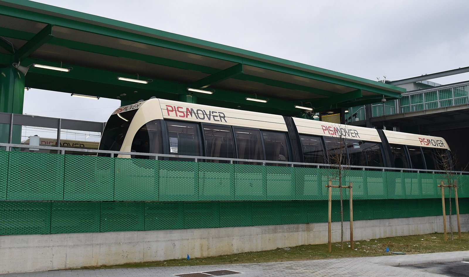 The small PisaMover shuttle train on its raised track