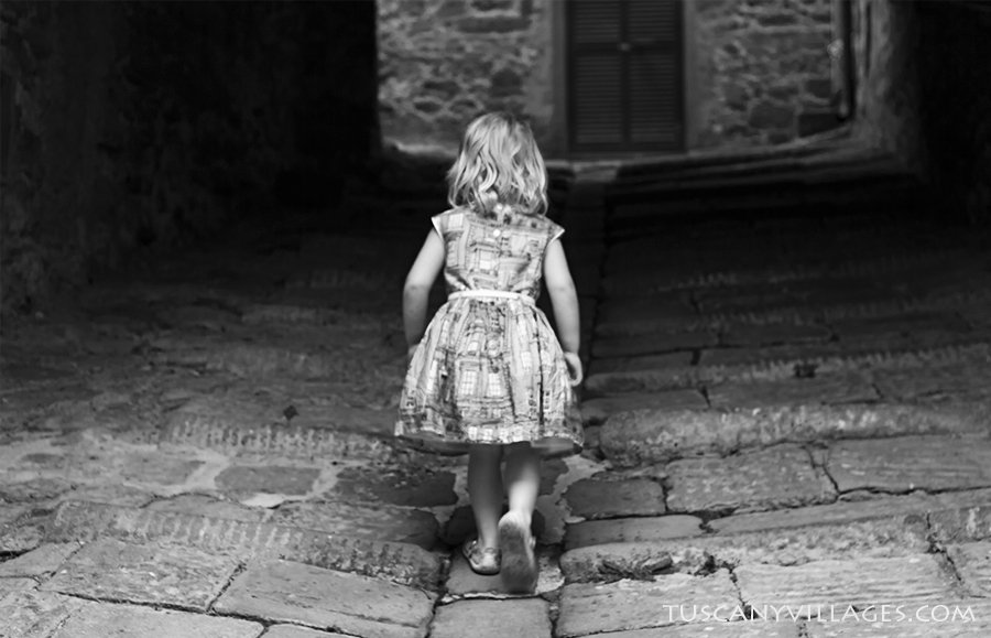 A child walking up one of the stone tunnels under the houses of Stiappa, in black and white