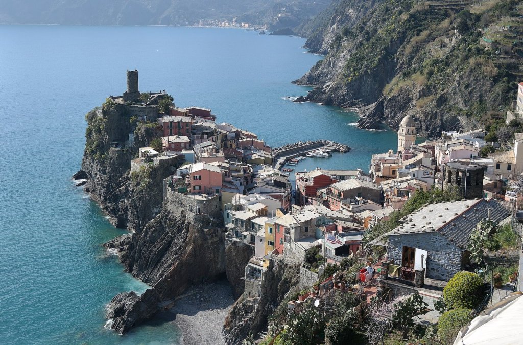 The colourful houses of Vernazza crowded on a rocky headland above its little harbour